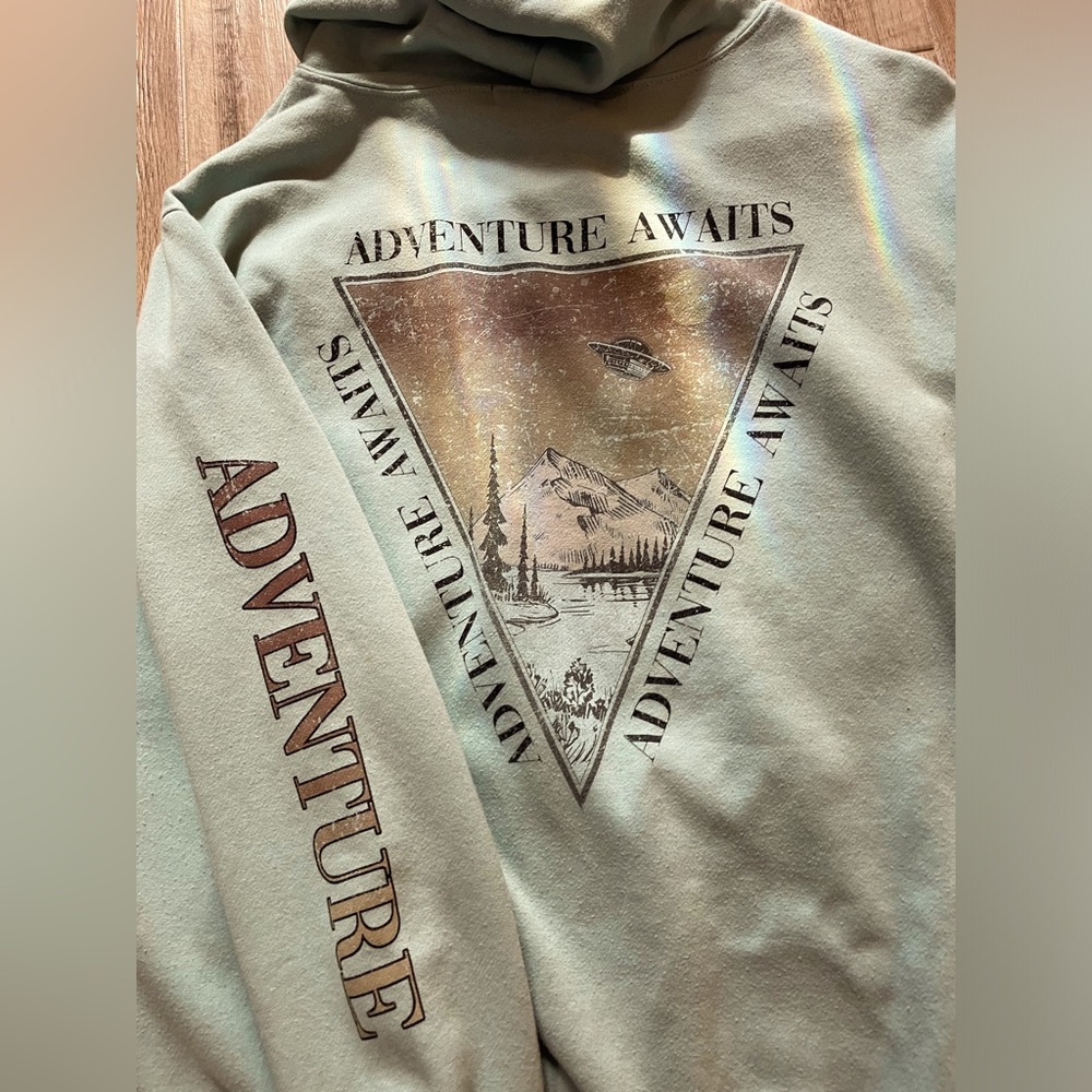 hoodie, with adventure on the sleeve,a triangle on the front,back with mountains